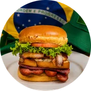 Sanduíches: X-Tudo - Hambúrguer (Ingredientes: Alface, Bacon, Calabresa, Carne, Ovo, Pão, presunto de peru, Queijo, Salsicha, Tomate)