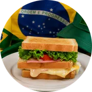 Sanduíches: Americano - Hambúrguer (Ingredientes: 3 fatias de pão de forma, Adicional maionese caseira G, Ovo, presunto de peru, Queijo, Tomate)